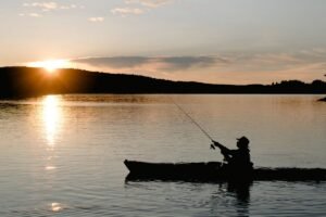 Teleskop fiskestang best i test, sammenslått teleskopstang i karbon ved siden av en dagstursekk på svaberg